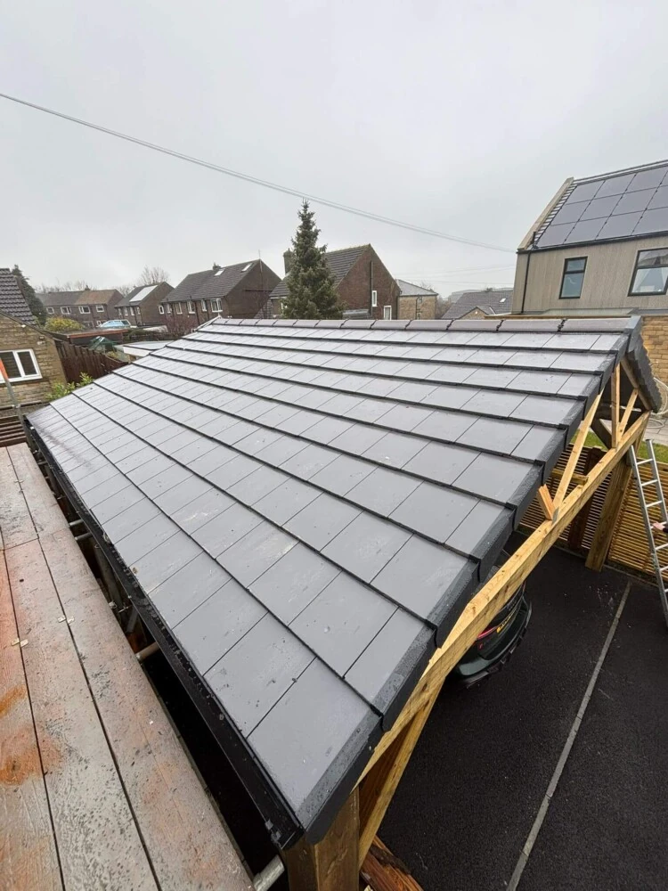 Slate roof on an extension under construction with exposed timber framing